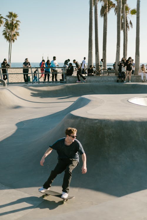 Free Man riding a Skateboard on a Skatepark  Stock Photo