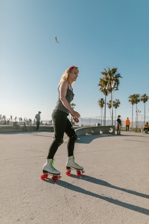 Free A Woman in Black Pants Skating on the Street Stock Photo