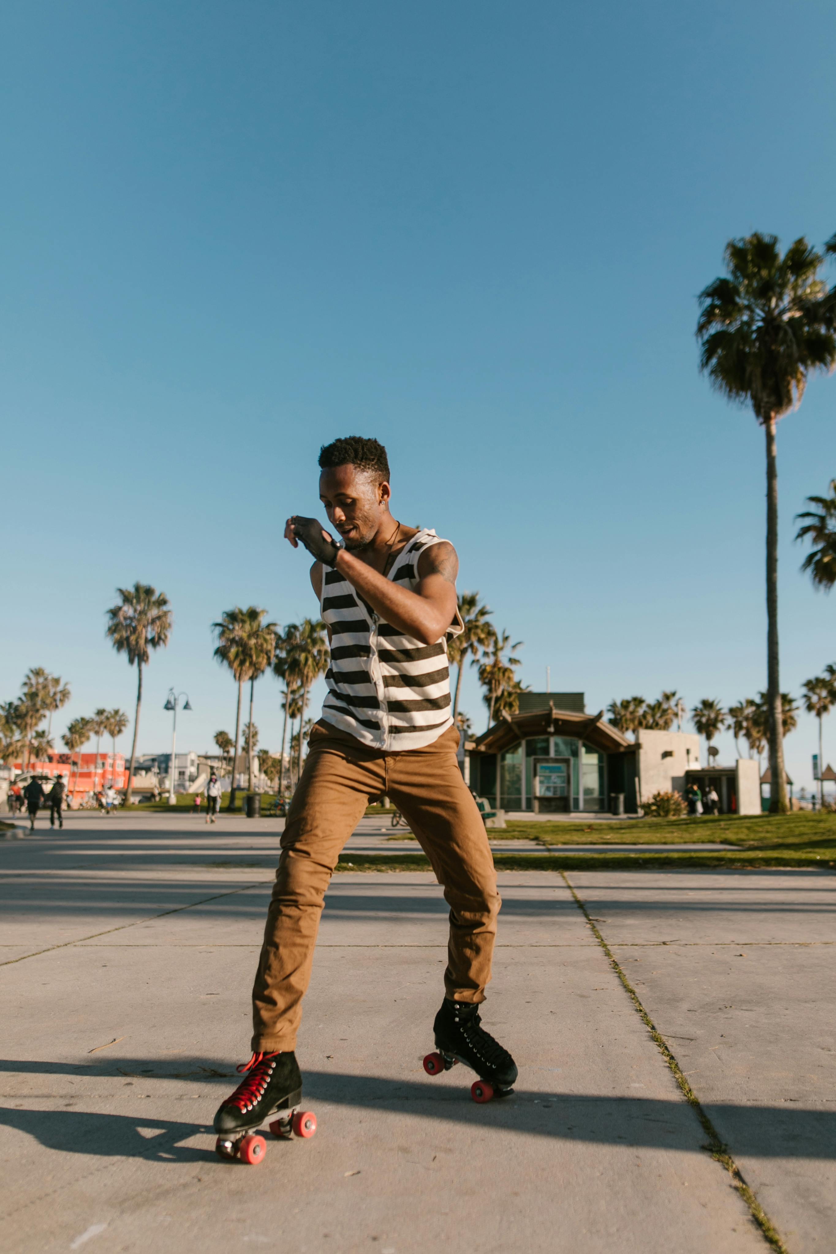 a man in a striped tank top roller skating