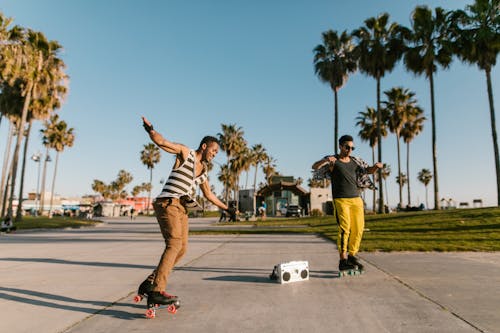 Free Men Dancing on the Street while Skating Stock Photo