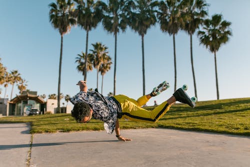 Man in Blue T-shirt and Black Pants Lying on Green Hammock