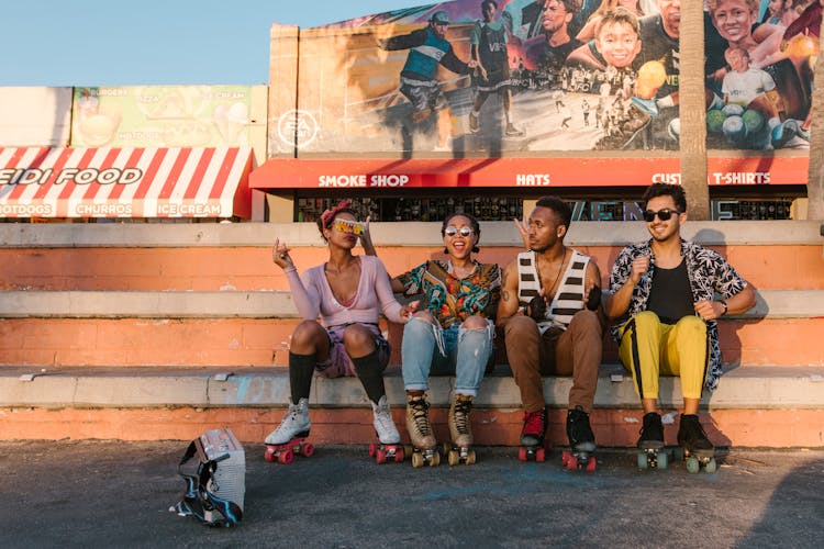 Group Of People Sitting On Concrete Bench