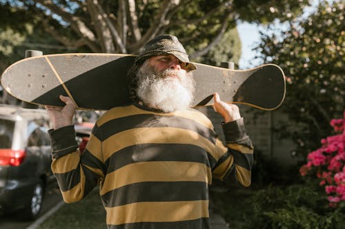 Free Shallow Focus of a Bearded Man Carrying His Skateboard Stock Photo
