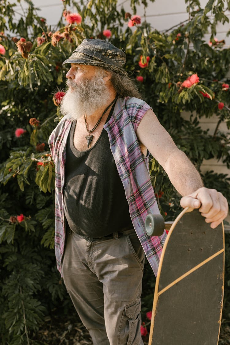 Elderly Man Holding A Long Board