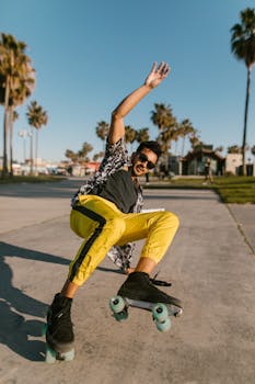 Trendy young man roller skating outdoors in bright sunlight, showcasing vibrant street style.