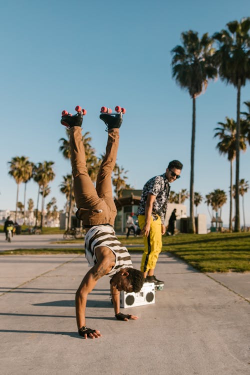 Free Man Doing Hand Stand while Wearing Roller Skates Stock Photo