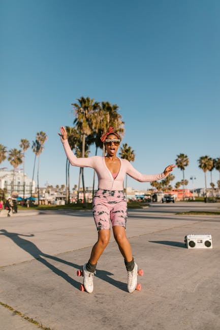 Stylish woman roller skating at a beachside park with palm trees under a clear blue sky.