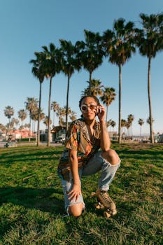 Stylish young woman roller skating outdoors under sunny palm trees.