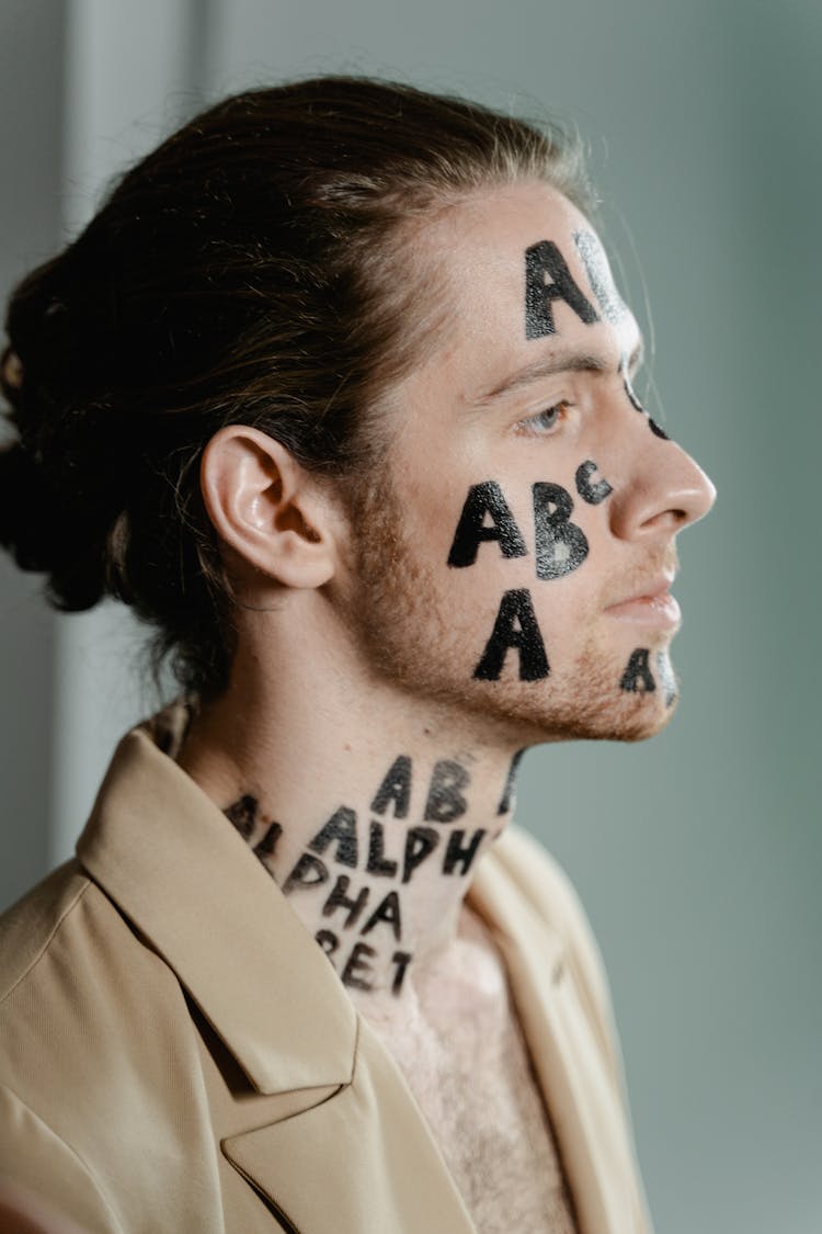 A Man With Letters On His Face