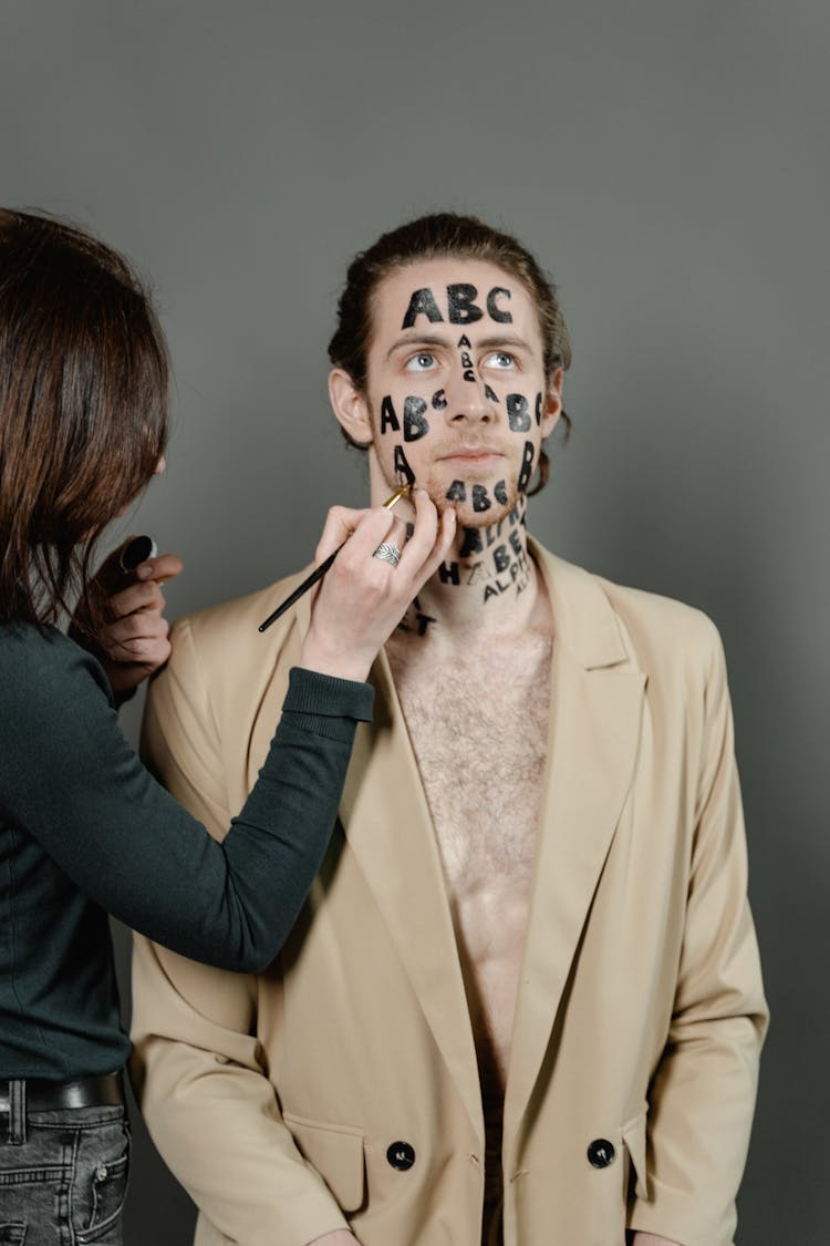 Woman Painting Man's Face 