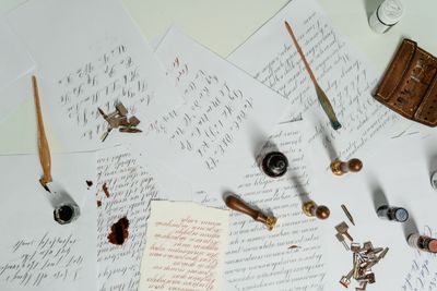 Lettering study laid out with ink bottle and nib pens — photo by MART PRODUCTION on Pexels