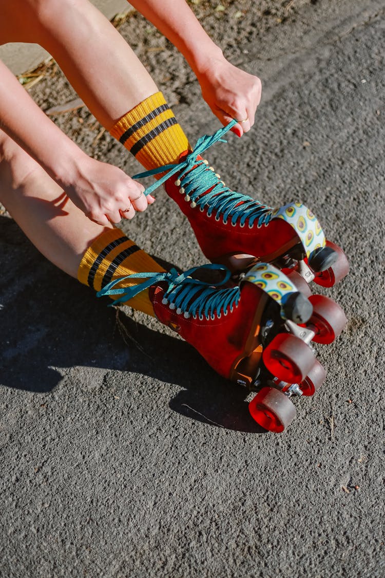 A Person Tying Roller Skates