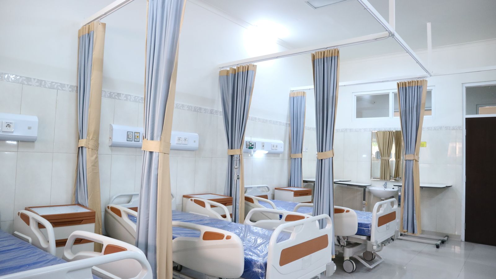Empty hospital beds in a clinical ward
