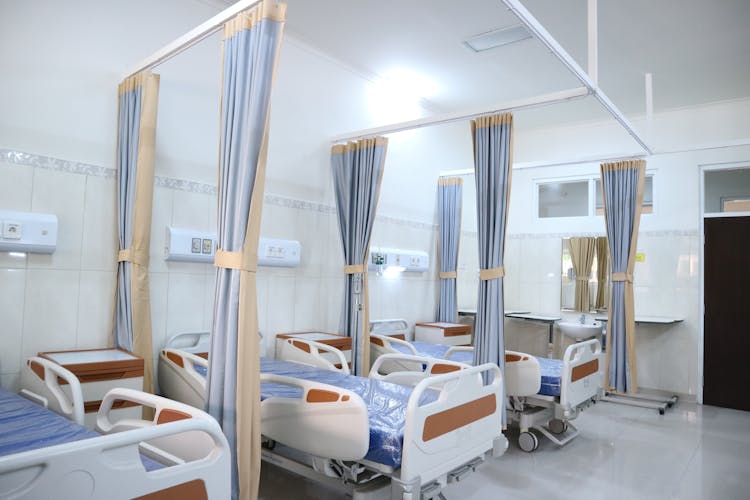 White And Brown Hospital Beds