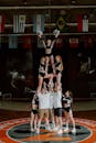 Cheerleaders Creating Cheer Pyramid in Gym