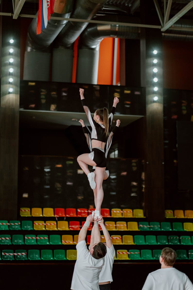 A Cheerleading Team Practicing In A Gym