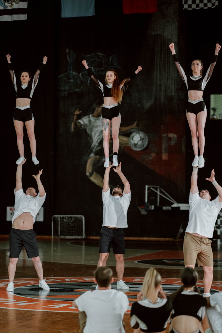 Group Of People Practicing Their Team Stunts