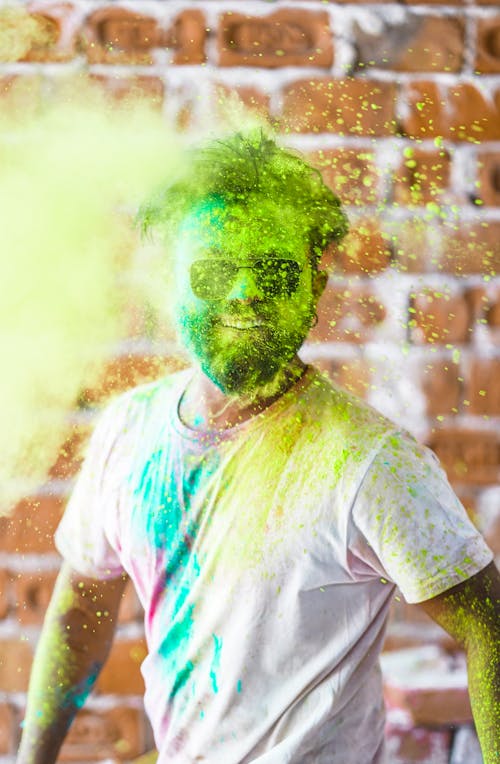 Man in White Crew Neck T-shirt With Green Powder on His Face
