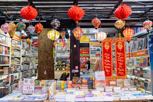 Free Local book shop with collection of various literature on bookshelves with traditional red decorative Chinese lanterns and hieroglyphs in city Stock Photo