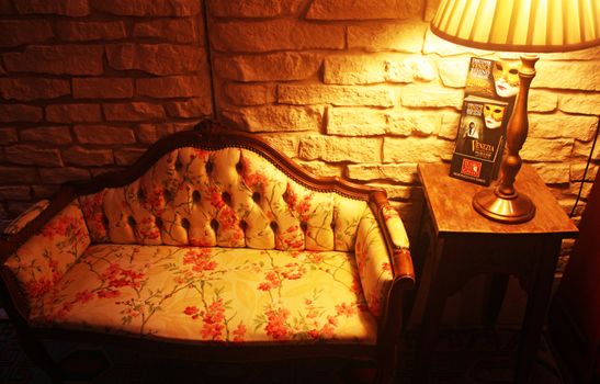 A cozy, vintage-style living room with floral sofa and warm lighting in Venice.