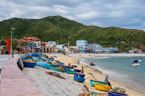 Sandy beach with boats on sea shore