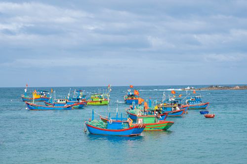 Free Colorful canoes floating on rippling sea water under cloudy blue sky in sunny day Stock Photo
