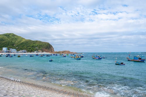 Free Sandy beach with boats on sea shore Stock Photo