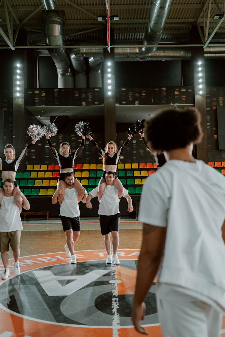 
A Cheerleading Team Practicing In A Gym