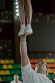 Close-up of a cheerleader lifted high, showcasing teamwork and balance.