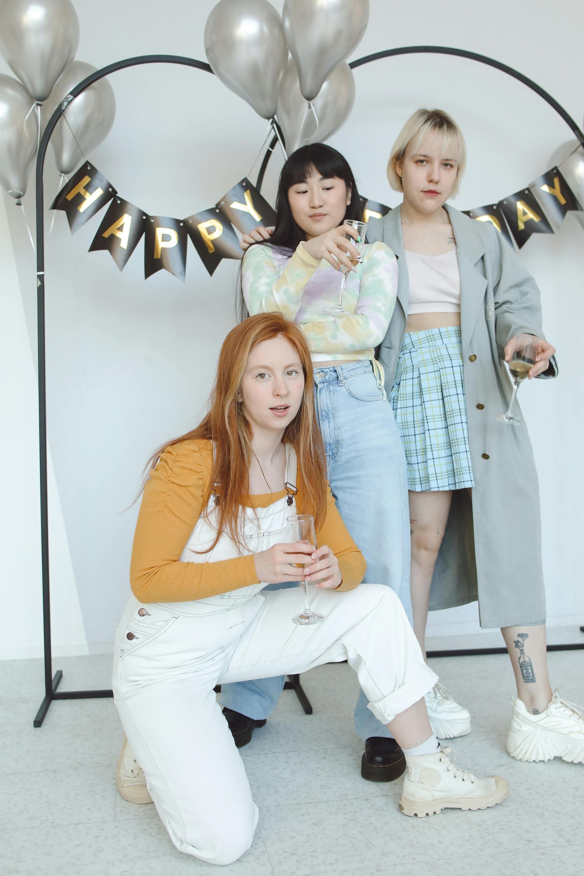 three girls in front of decoration happy birthday