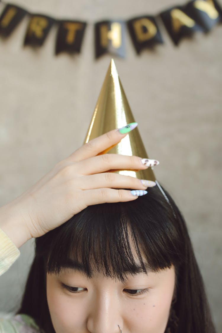 Young Woman With Golden Birthday Hat And Long Nails