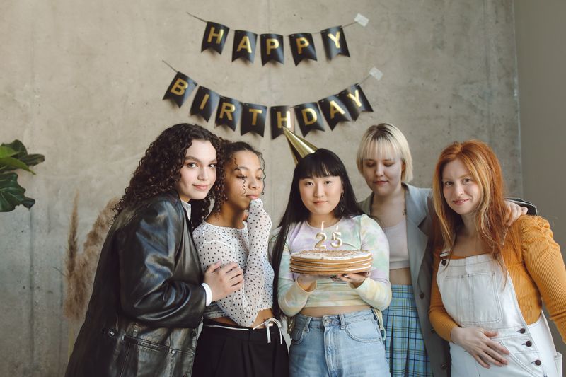 Friends celebrating a birthday with cake and sparklers