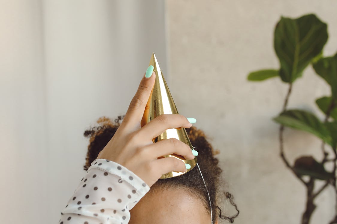 Free Close-up of Woman Putting Party Hat on Head Stock Photo
