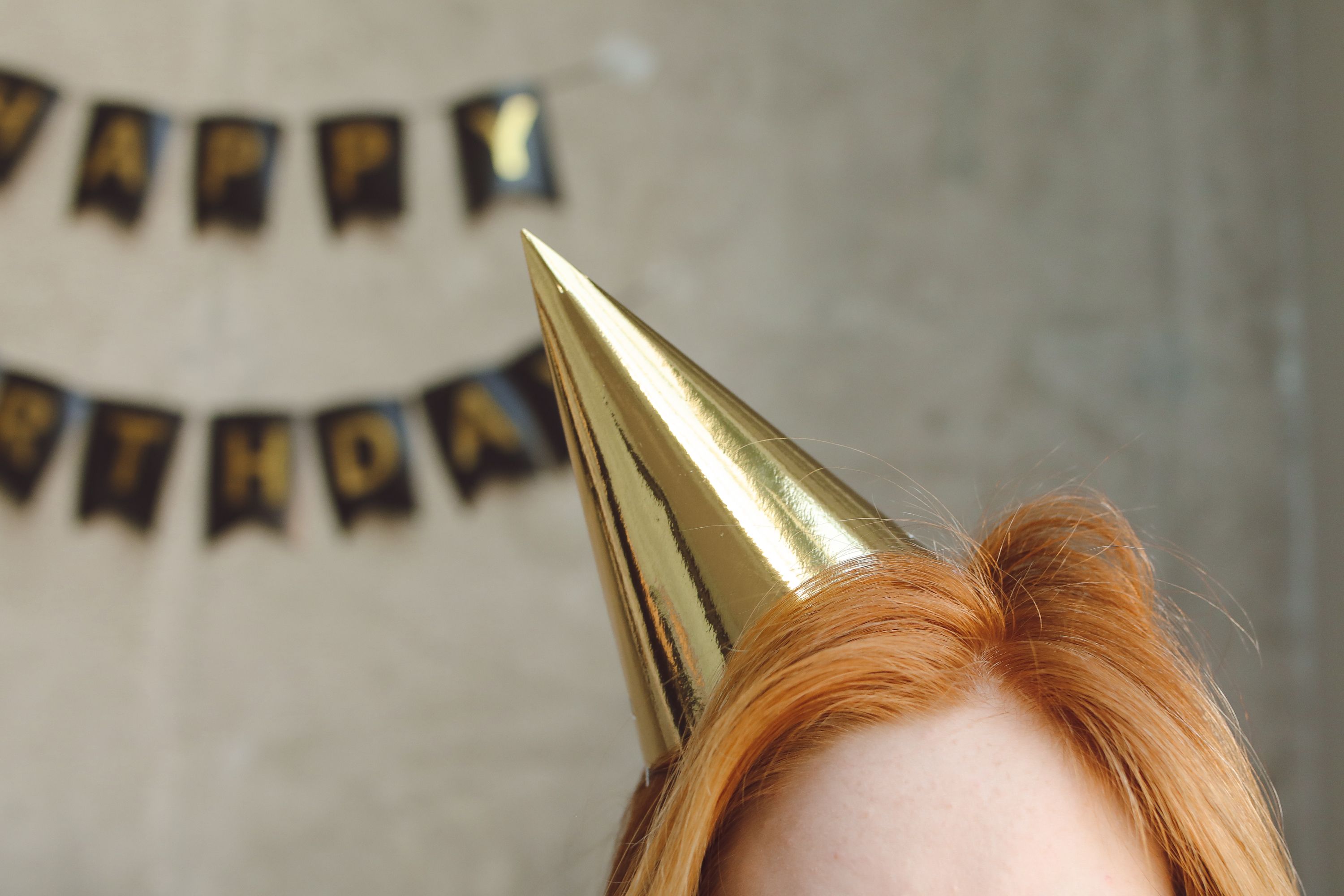 dog wearing a gold party hat with numbers - birthday hat on dog