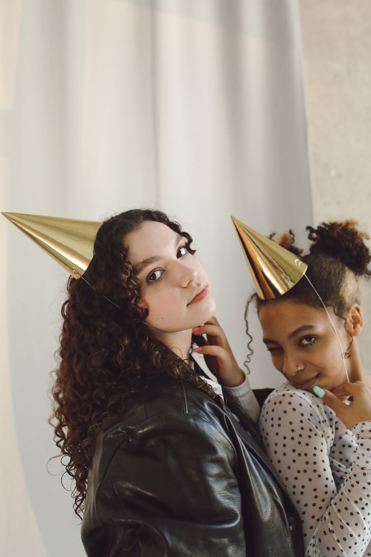 Two Girls Wearing Gold Party Hat