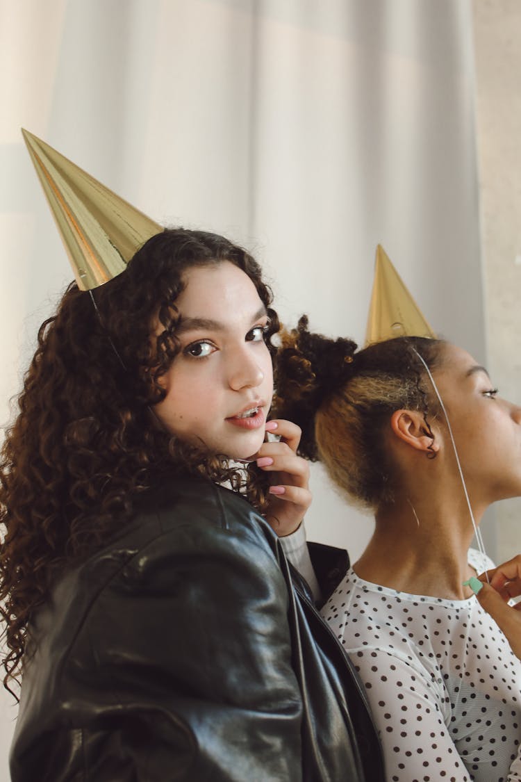 Two Girls Wearing Gold Party Hat