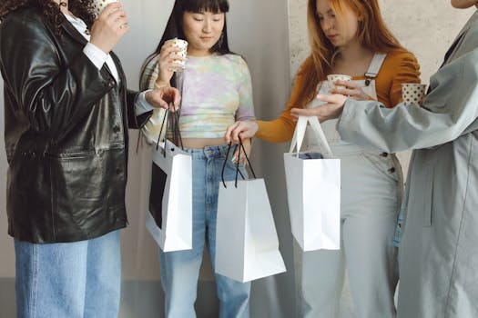 A group of young women carrying shopping bags and drinking coffee indoors. Perfect for lifestyle and leisure themes.