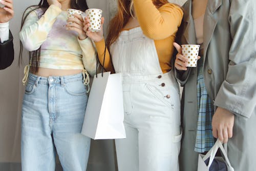 Women Holding Polka Dots Paper Cups