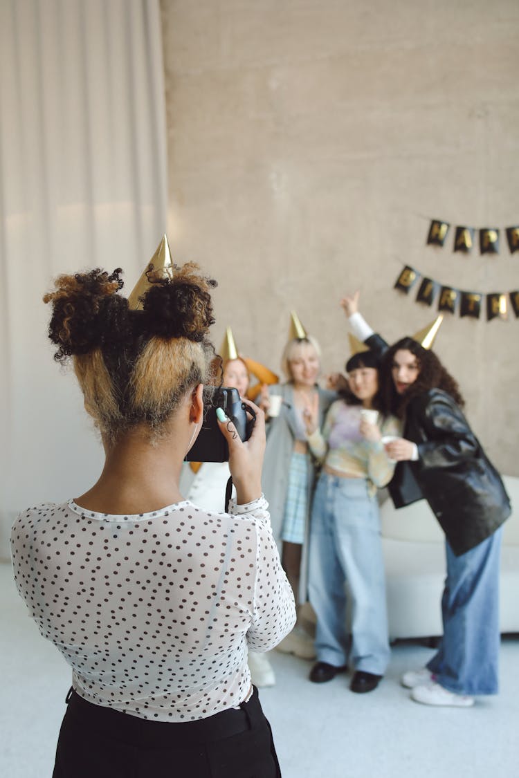 Woman Taking Picture Of Friends Celebrating Birthday