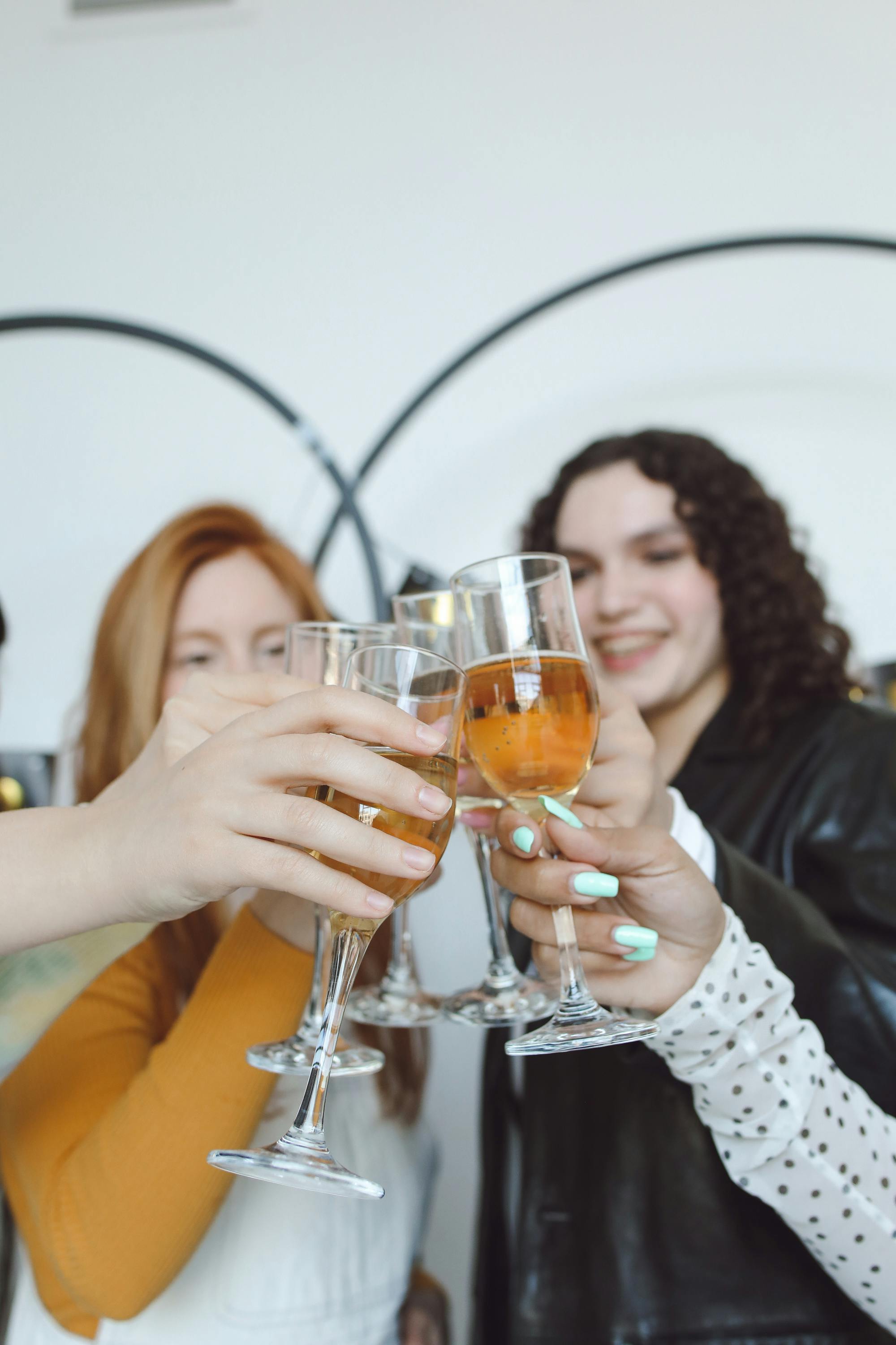 photo of girls doing a toast with their glasses