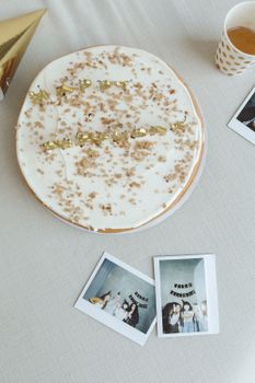 Celebrate with a delicious cake and nostalgic photos, perfect for a special occasion.