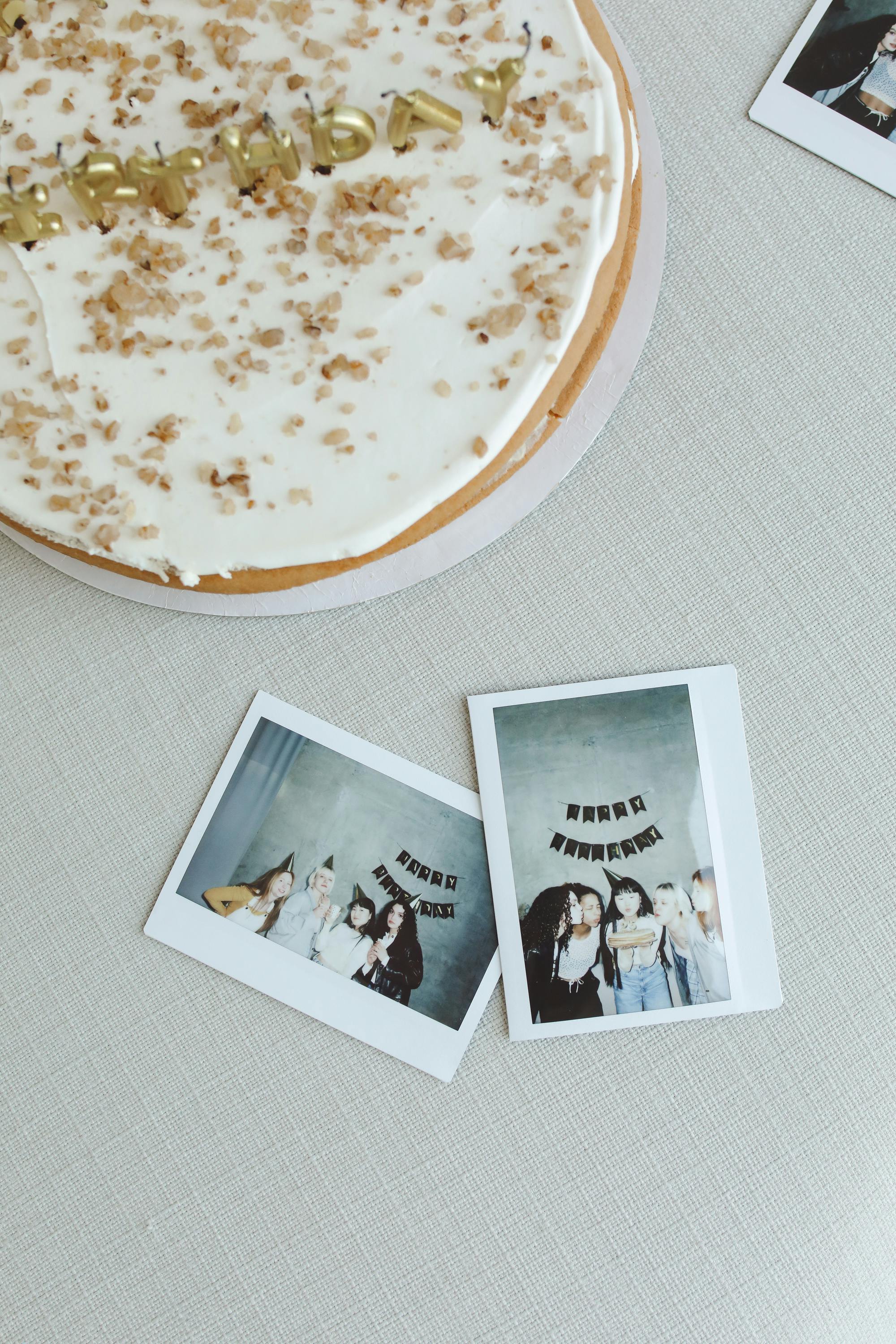 A birthday celebration scene featuring a cake and instant photos capturing joyful moments.