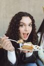 Woman in White Long Sleeve Shirt Holding White Ceramic Plate With Brown and White Cake