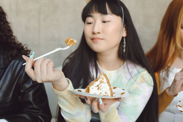 A Girl Eating A Cake