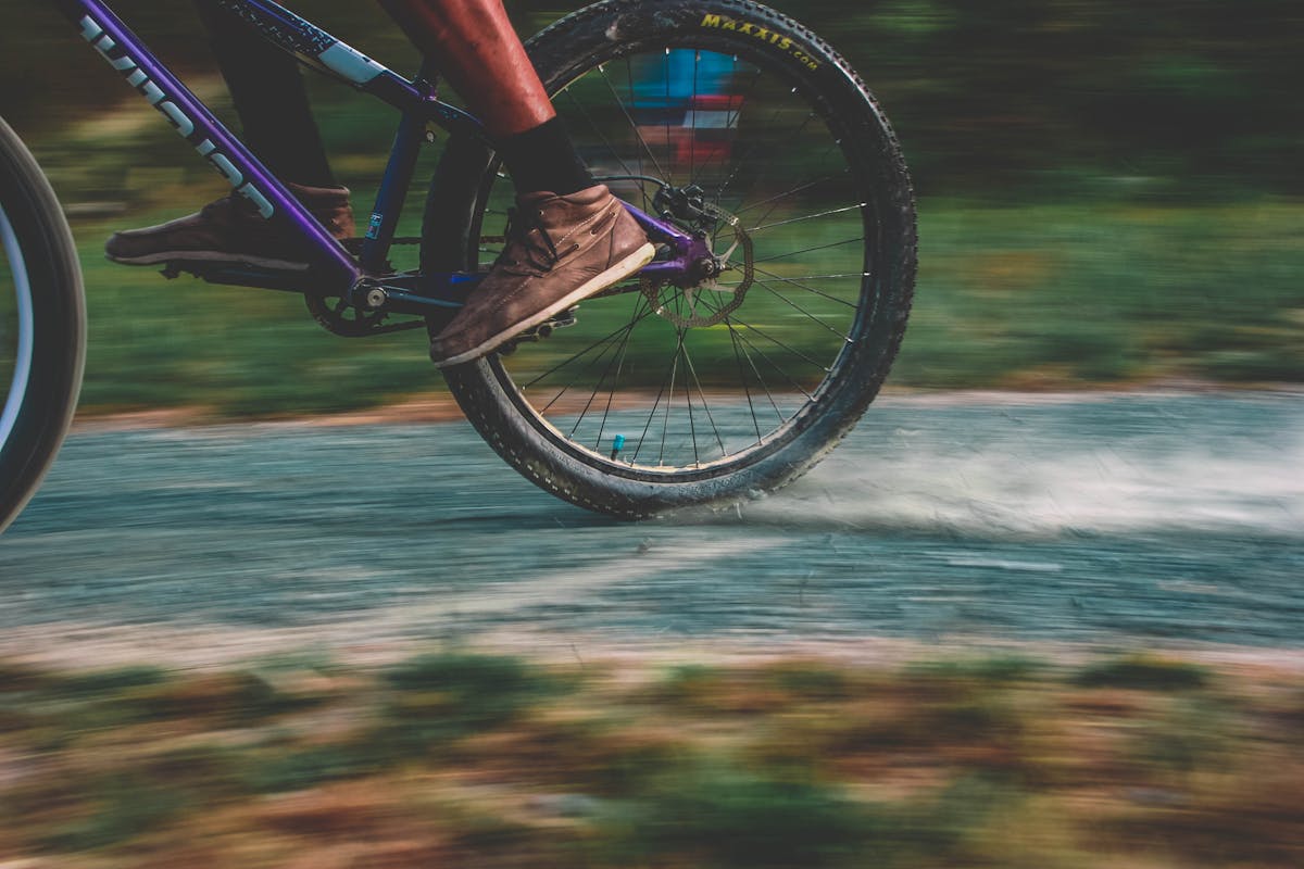 Gravel cyclist riding through open countryside on a dirt path