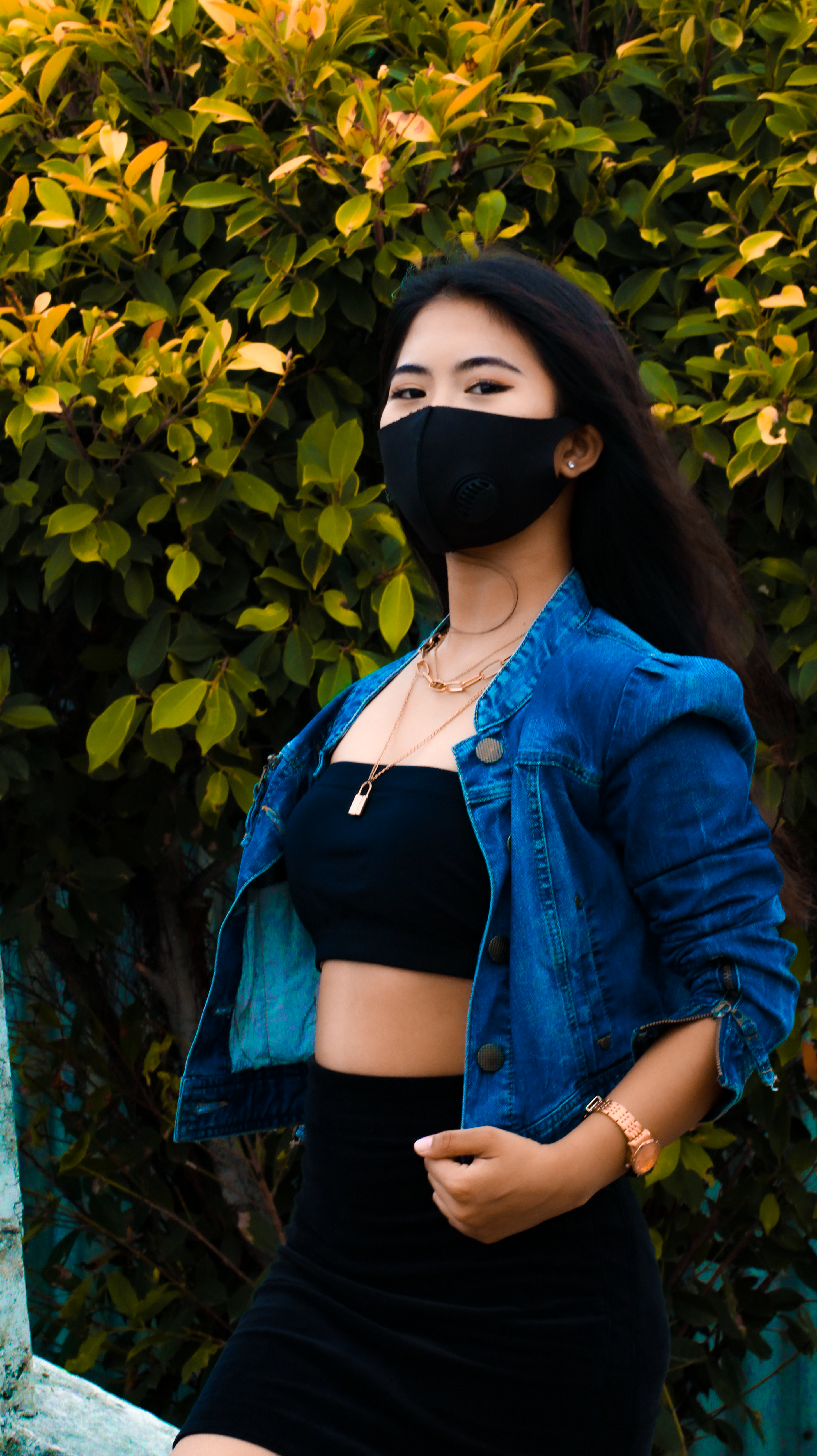Woman in Blue Denim Jacket and Black Tube Top Wearing Black Face Mask ...