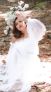 Woman in White Dress Standing on Dried Leaves