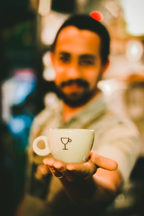 Free Focus Photography of Man Holding Ceramic Teacup Stock Photo
