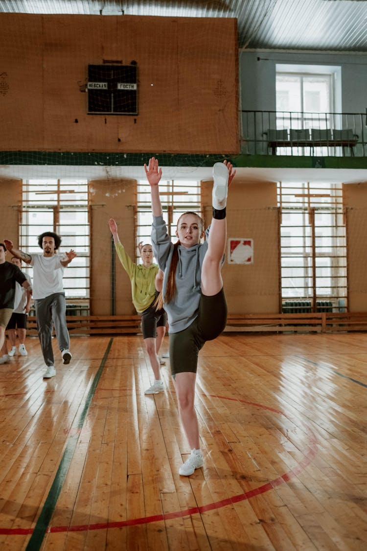 Woman In Gray Sweatshirt Exercising In A Gym