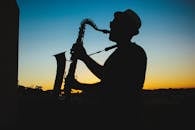 Silhouette of a Man Playing Saxophone during Sunset